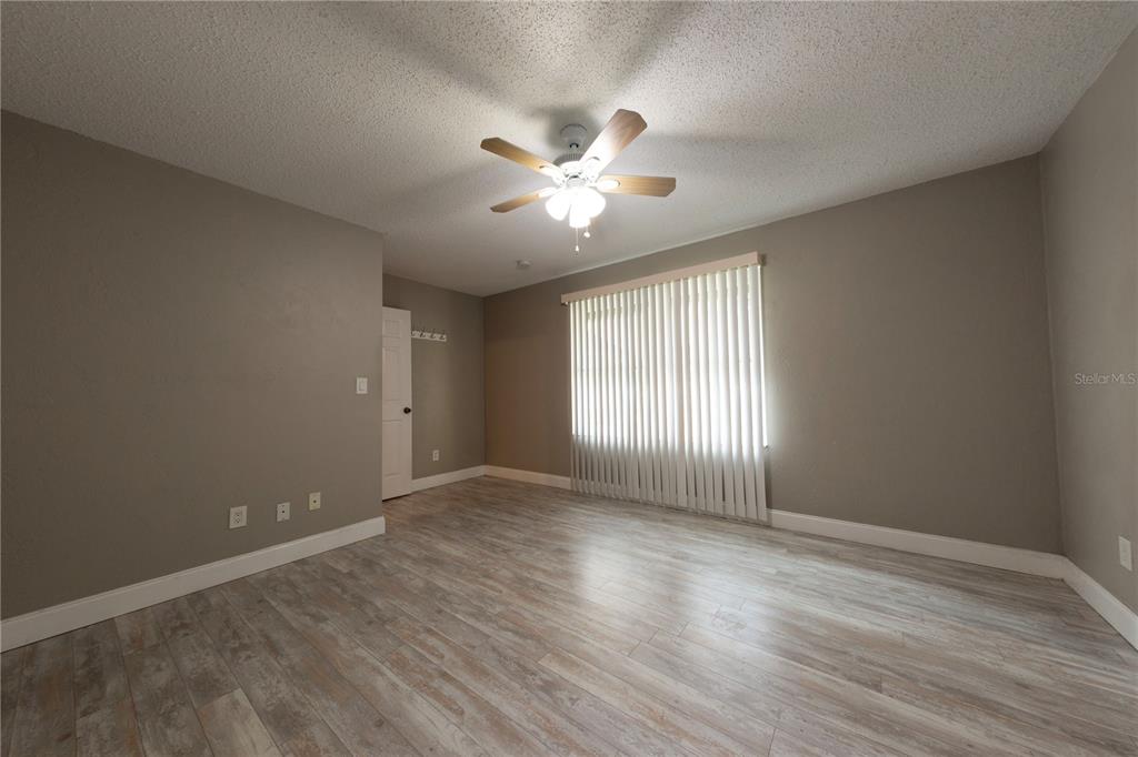 232 North Ridgewood Avenue, Unit 3A Edgewater, FL 32132 - Photo 9 of 19 a view of an empty room with window and wooden floor