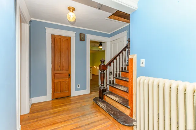 a view of entryway with stairs and wooden floor