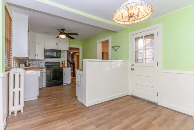 a view of kitchen with cabinets and wooden floor