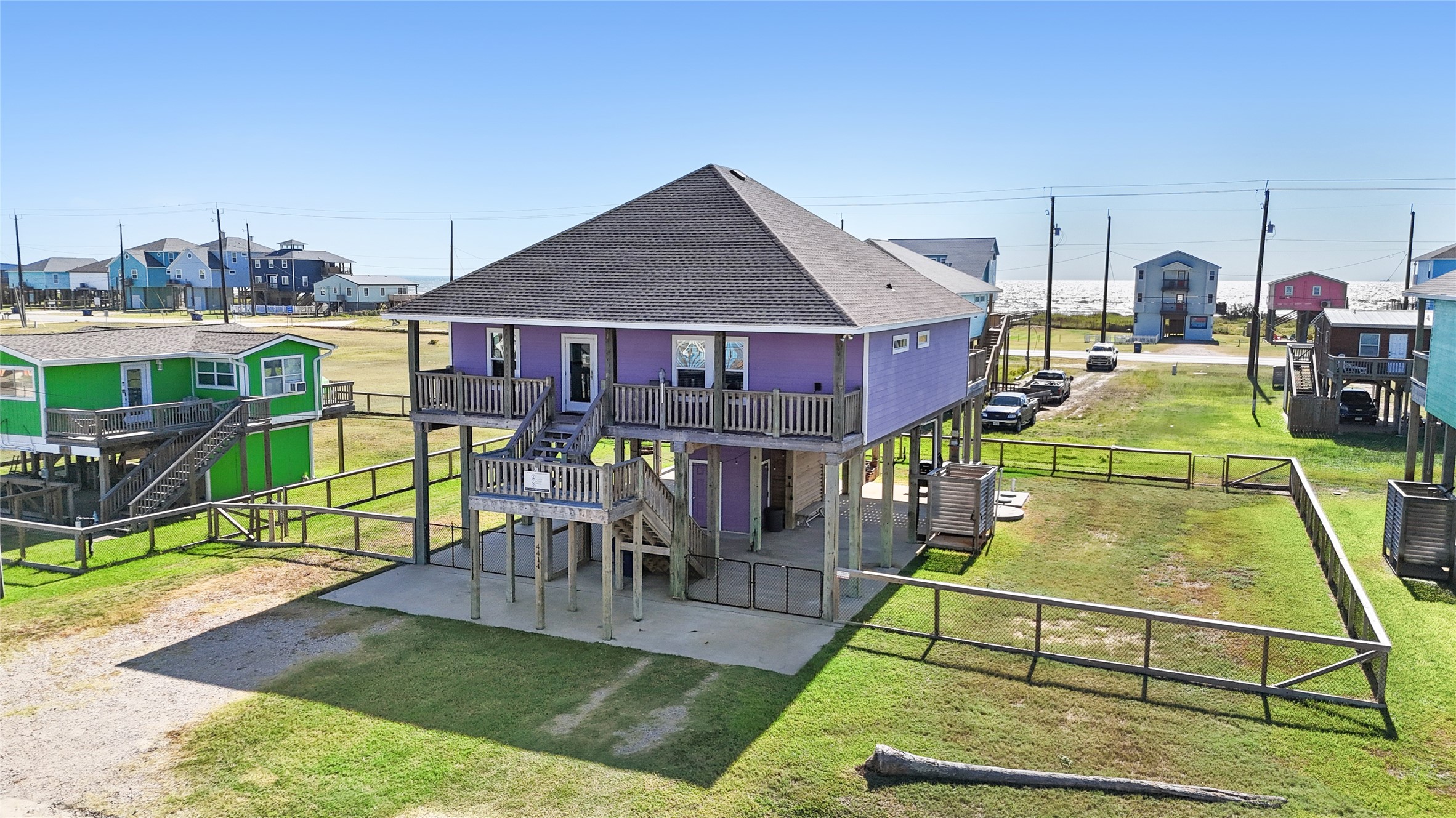 a view of a house with swimming pool lawn chairs and a yard