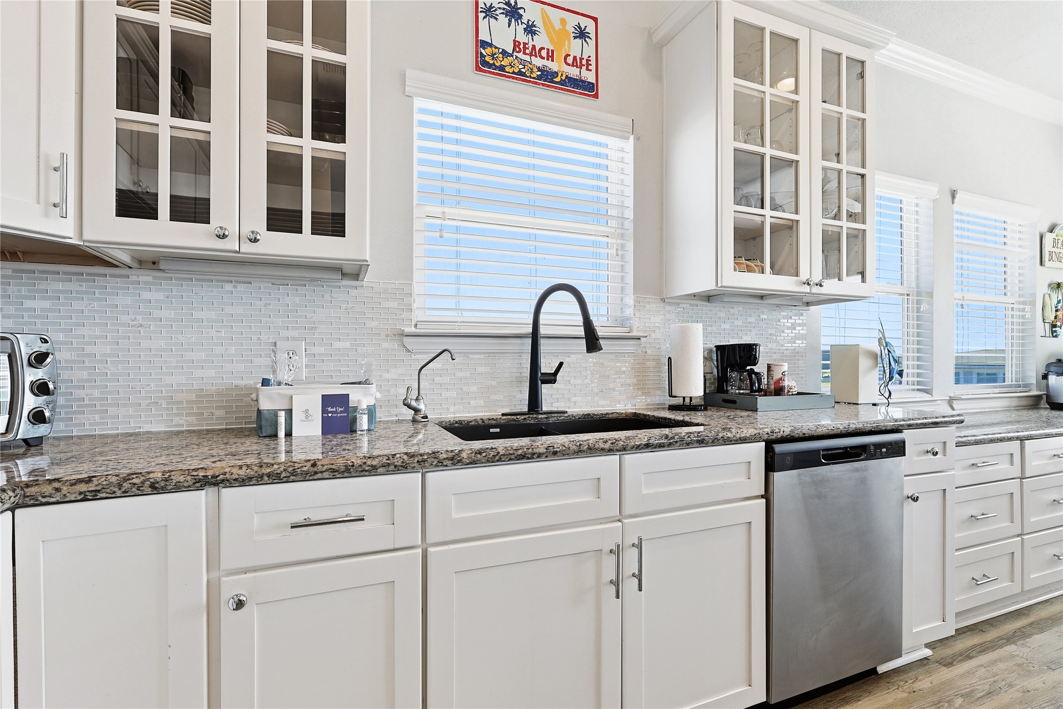 4414 Palm Street Freeport, TX 77541 - Photo 12 of 35 a kitchen with granite countertop stainless steel appliances sink and cabinets