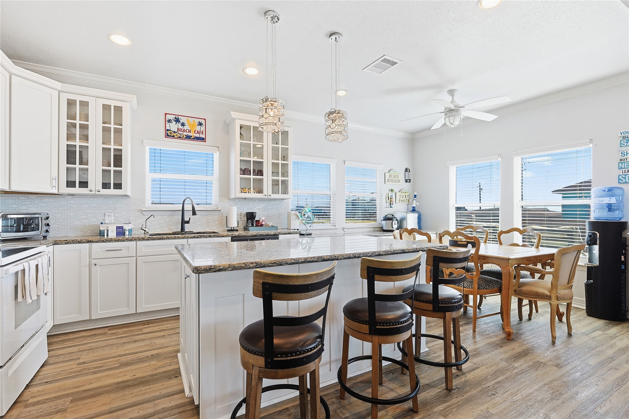4414 Palm Street Freeport, TX 77541 - Photo 8 of 35 a kitchen with a dining table chairs cabinets and stainless steel appliances