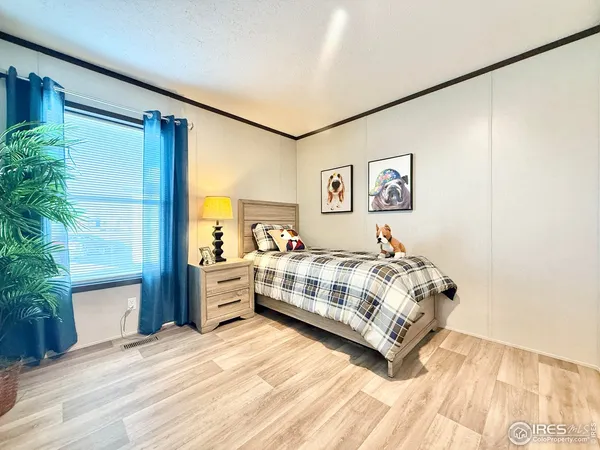 a bedroom with a large bed and a window