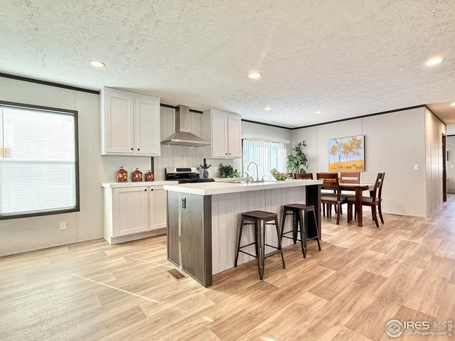 a kitchen with table chairs sink and cabinets
