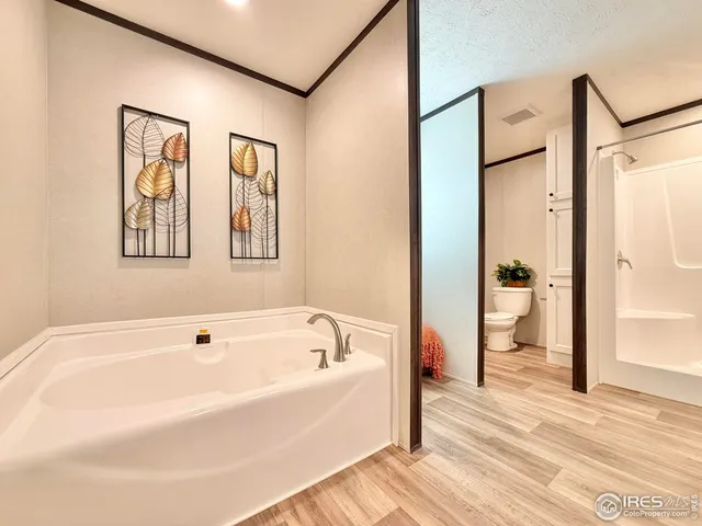 a white bath tub sitting next to a bathroom