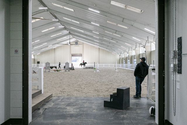 a spacious bedroom with a bed and a chandelier