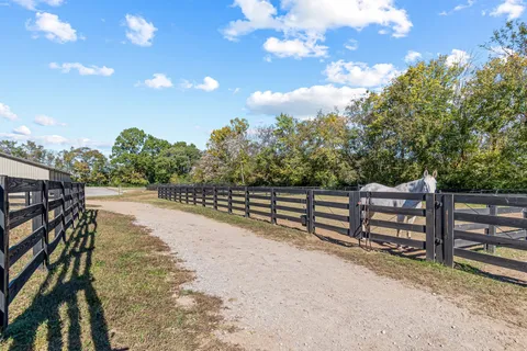 a view of a house with swimming pool and sitting area