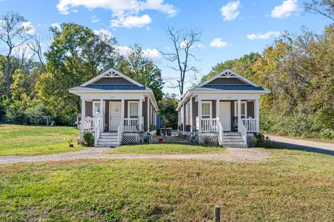 an aerial view of a houses with outdoor space and trees