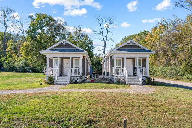 an aerial view of a houses with outdoor space and trees