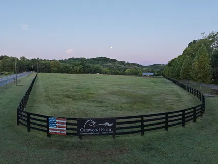 an aerial view of residential houses with outdoor space and lake view