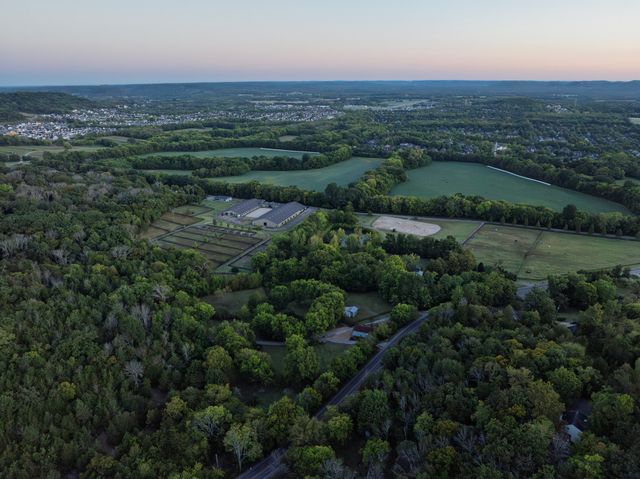 an aerial view of a house with yard
