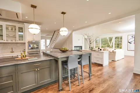 a kitchen with sink stove and cabinets