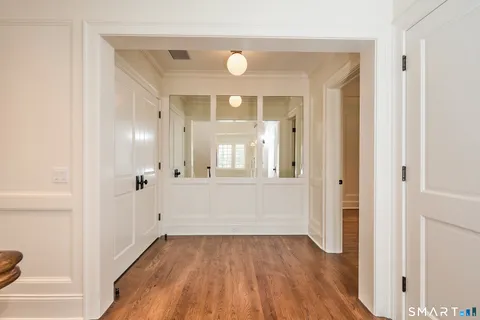 a spacious bedroom with a bed a couch and large window