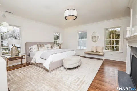 a spacious bedroom with a large bed and a fireplace