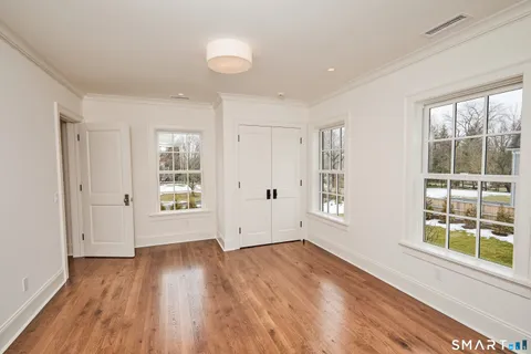a bathroom with a shower sink mirror and toilet