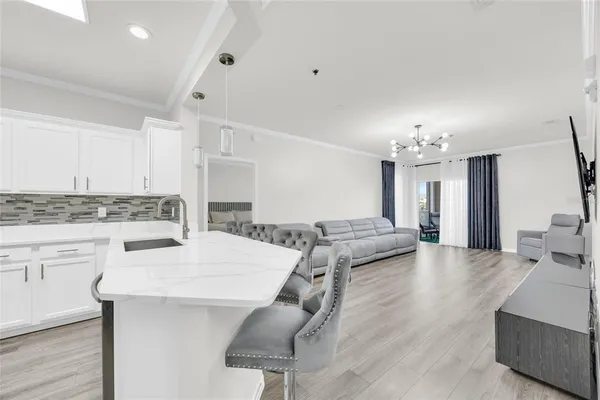a living room with kitchen island granite countertop furniture and a fireplace
