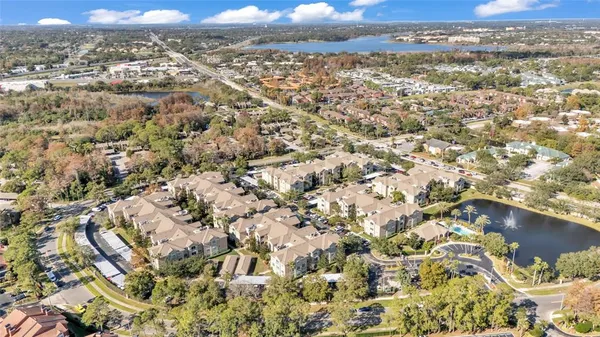 an aerial view of residential houses with city view