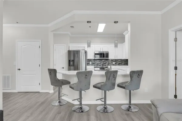 a kitchen with stainless steel appliances kitchen island granite countertop a refrigerator and a stove top oven