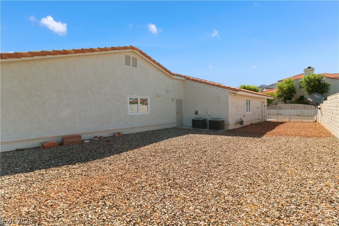 2055 Cholla Way Laughlin, NV 89029 - Photo 60 of 87 A spacious backyard with gravel landscaping offers easy maintenance and versatile outdoor living.