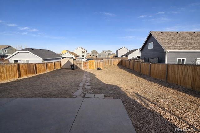 2768 Renshaw Street Strasburg, CO 80136 - Photo 14 of 14 a view of a house with wooden fence