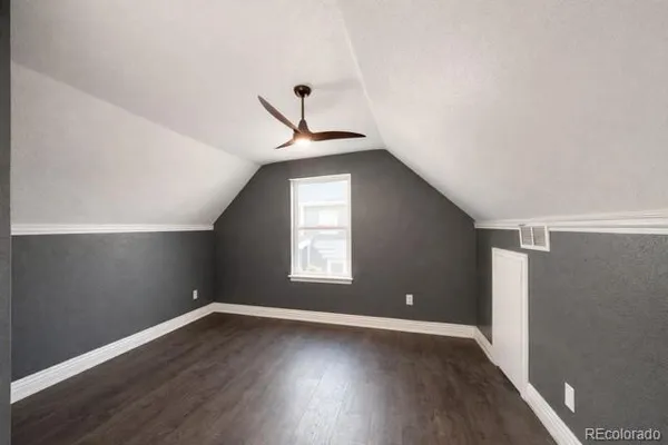 a view of a livingroom with wooden floor and window