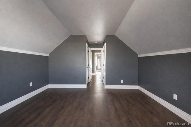 2768 Renshaw Street Strasburg, CO 80136 - Photo 9 of 14 an empty room with wooden floor and windows
