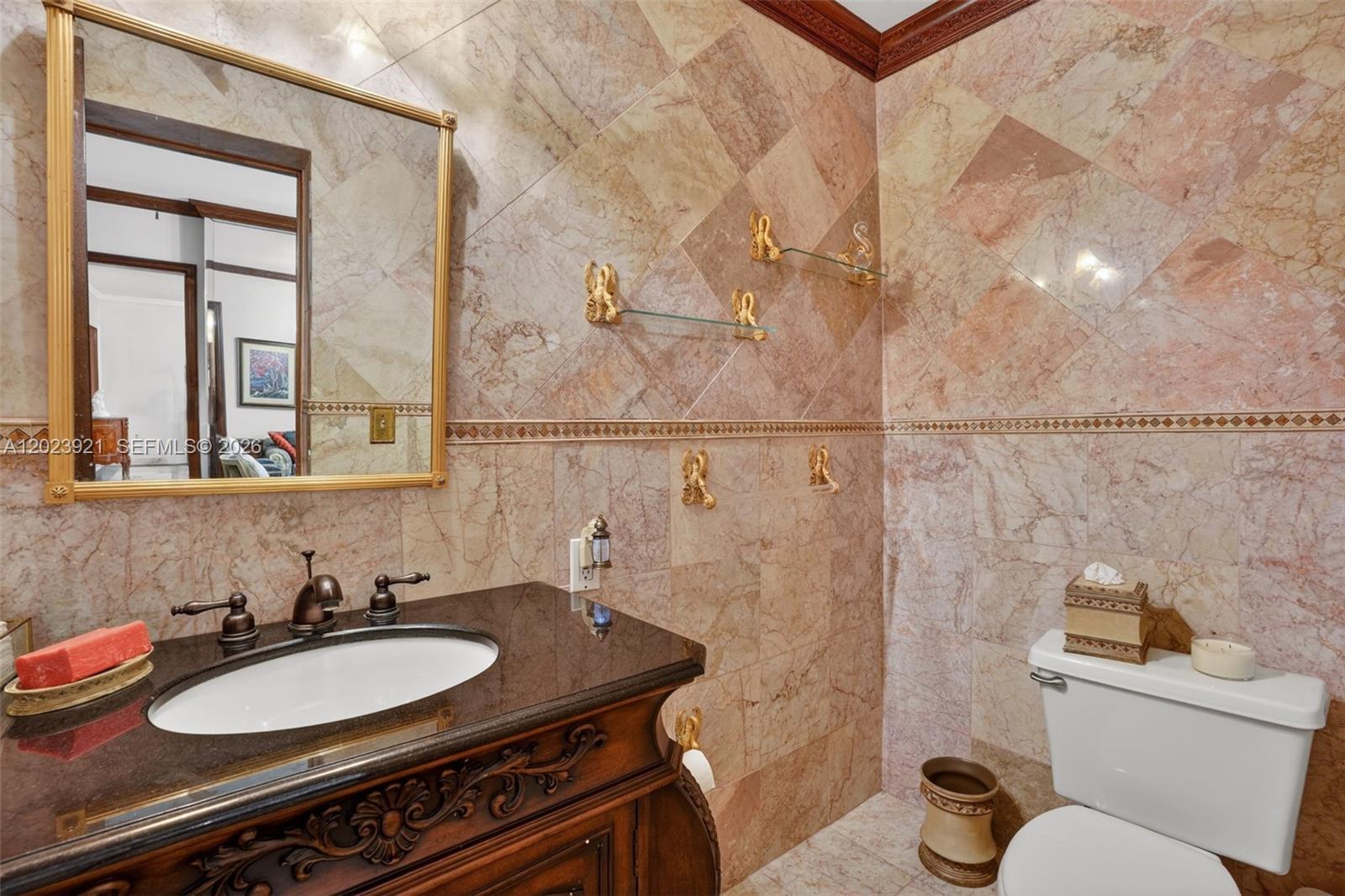 8461 Southwest 68th St Road Miami, FL 33143 - Photo 59 of 65 a bathroom with a sink and a mirror with toilet