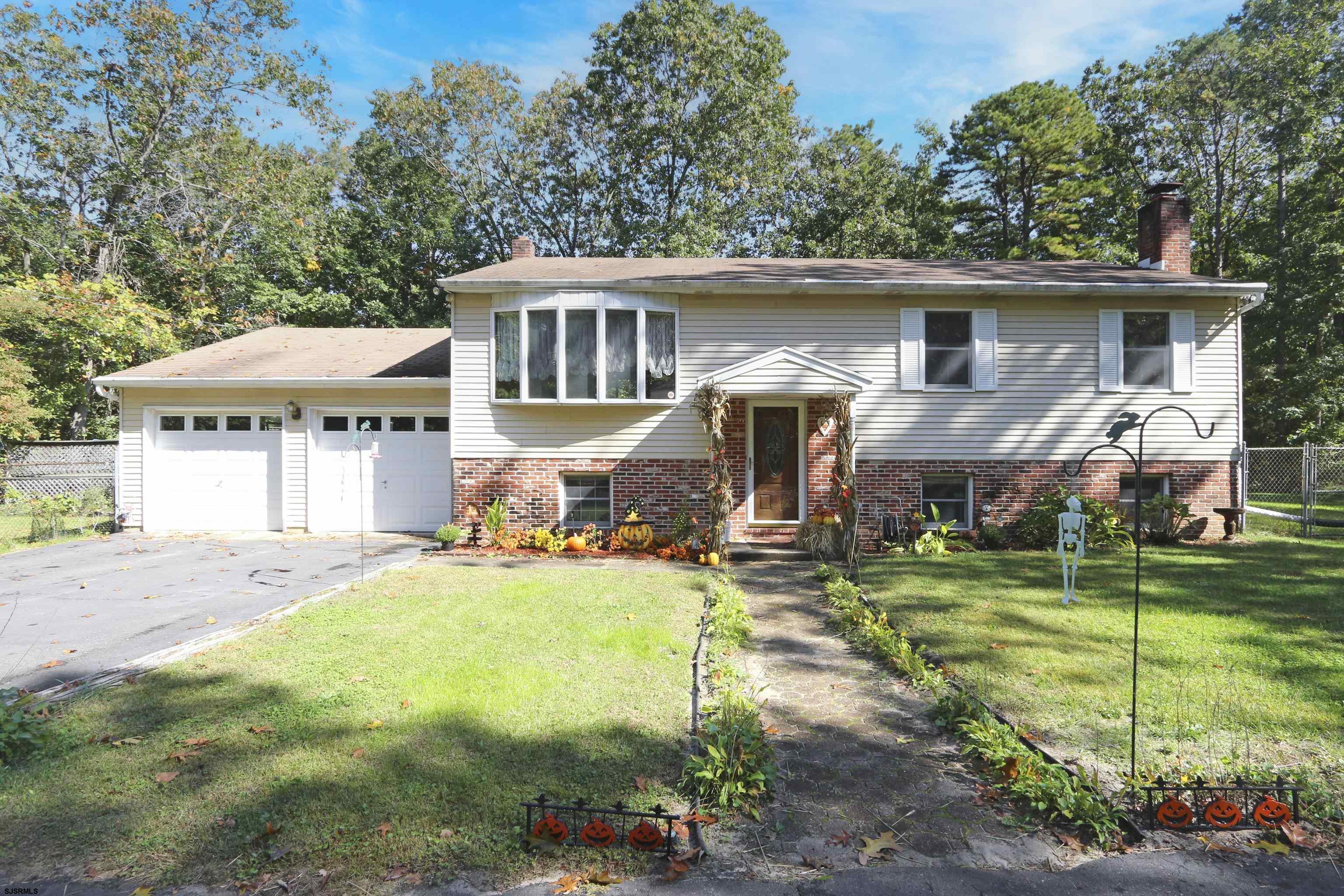 2203 Evergreen Drive Hammonton, NJ 08037 - Photo 1 of 39 a front view of a house with a yard table and chairs