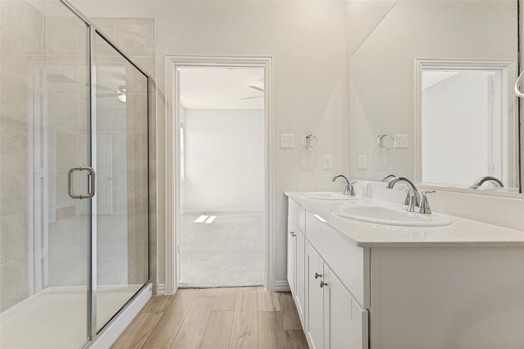 1237 Almond Road Azle, TX 76020 - Photo 11 of 24 a bathroom with a double vanity sink a mirror and a shower