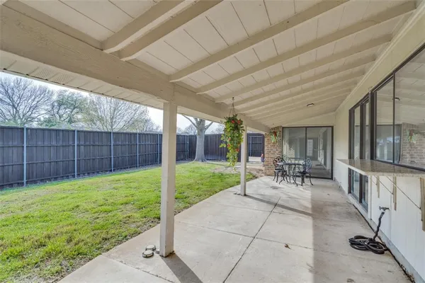 a view of a backyard with furniture and garden