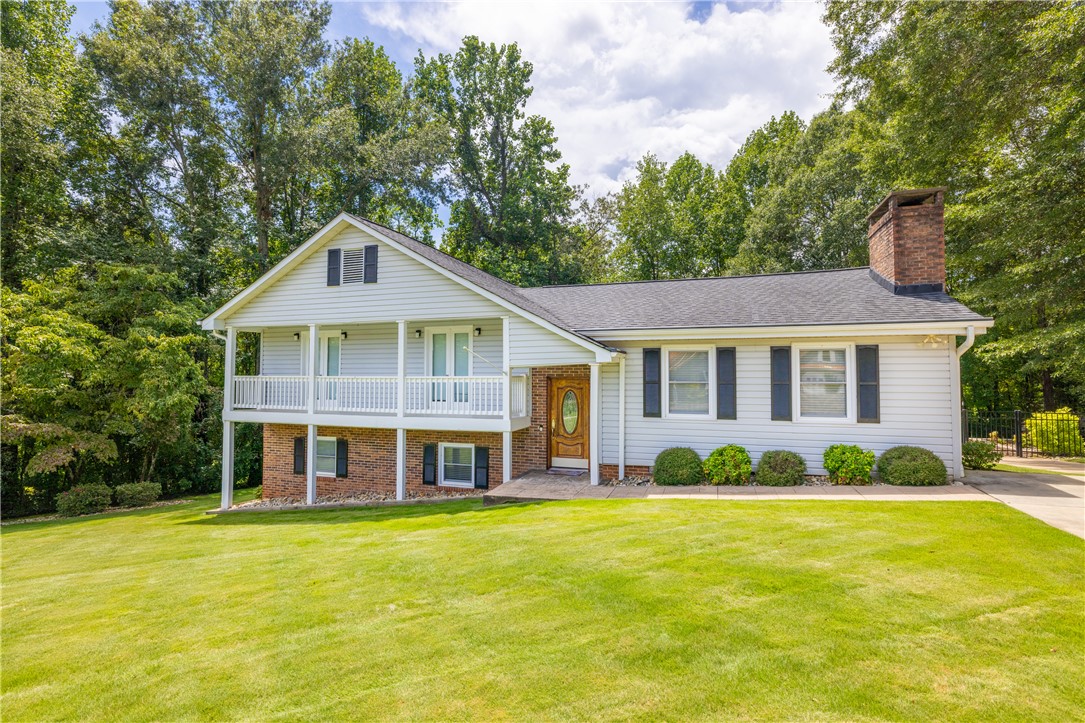 404 South Old Mill Road Seneca, SC 29678 - Photo 2 of 39 Mature trees frame a manicured lawn leading up to this multi-level home with dual decks.