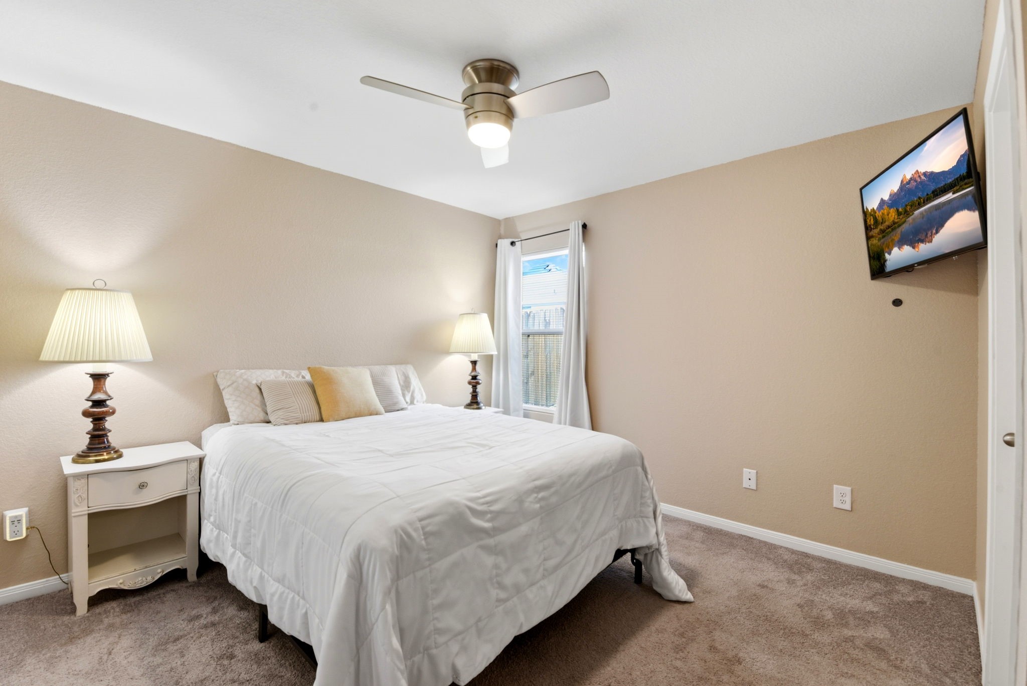 9819 Emerald Stone Way Conroe, TX 77306 - Photo 20 of 38 a bedroom with a bed and a chandelier