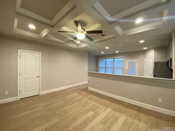 a view of an empty room with a ceiling fan