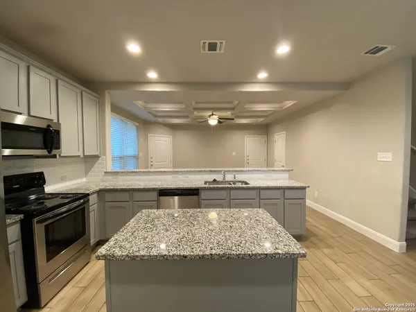 a kitchen with a stove and a sink