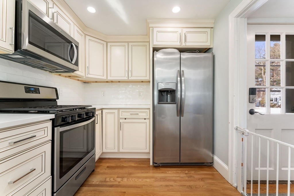 30 Hadley Road Framingham, MA 01701 - Photo 4 of 18 a kitchen with stainless steel appliances granite countertop a refrigerator and a stove top oven