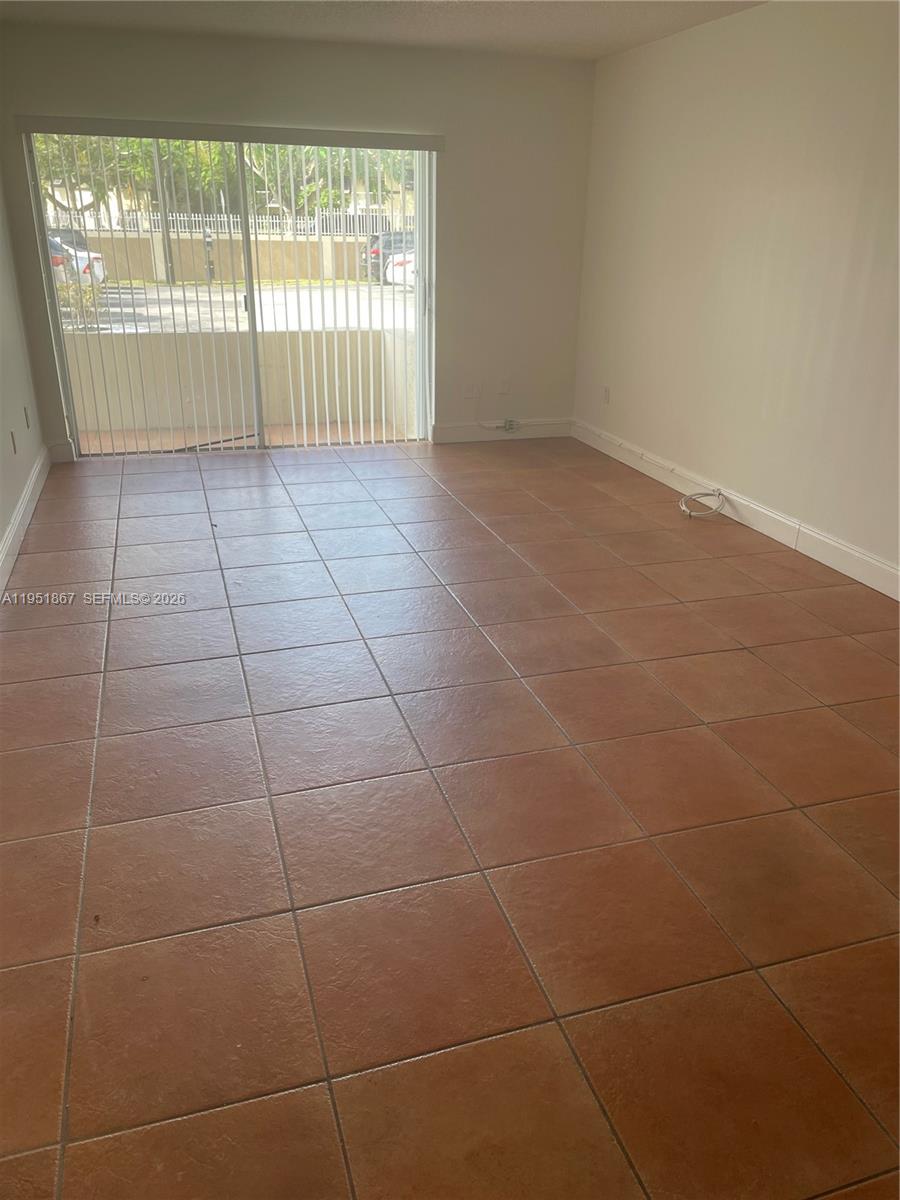 7785 Southwest 86th Street, Unit E123 Miami, FL 33143 - Photo 2 of 8 a view of an empty room with a window