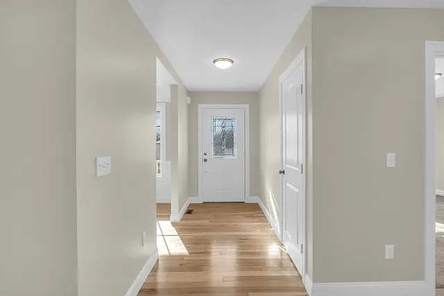 a view of a hallway with wooden floor