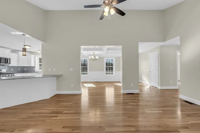 a view of a kitchen with wooden floor and a kitchen