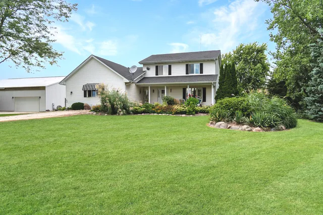 a front view of house with yard and green space
