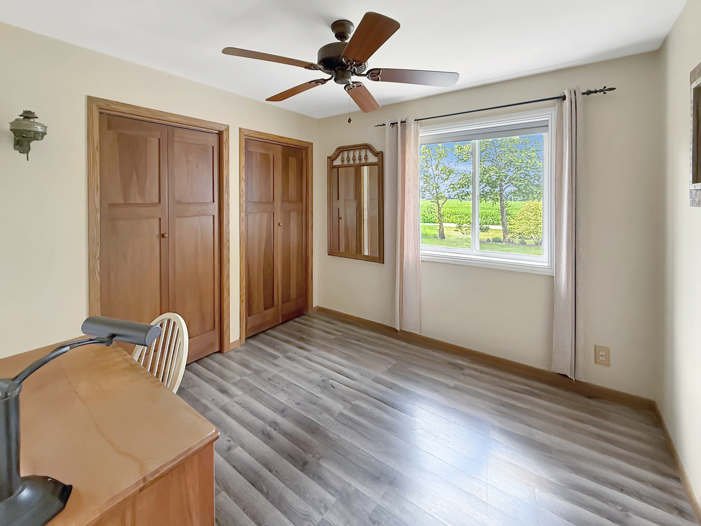 49W972 Peterson Road Maple Park, IL 60151 - Photo 18 of 38 a workspace with wooden floor windows and a ceiling fan
