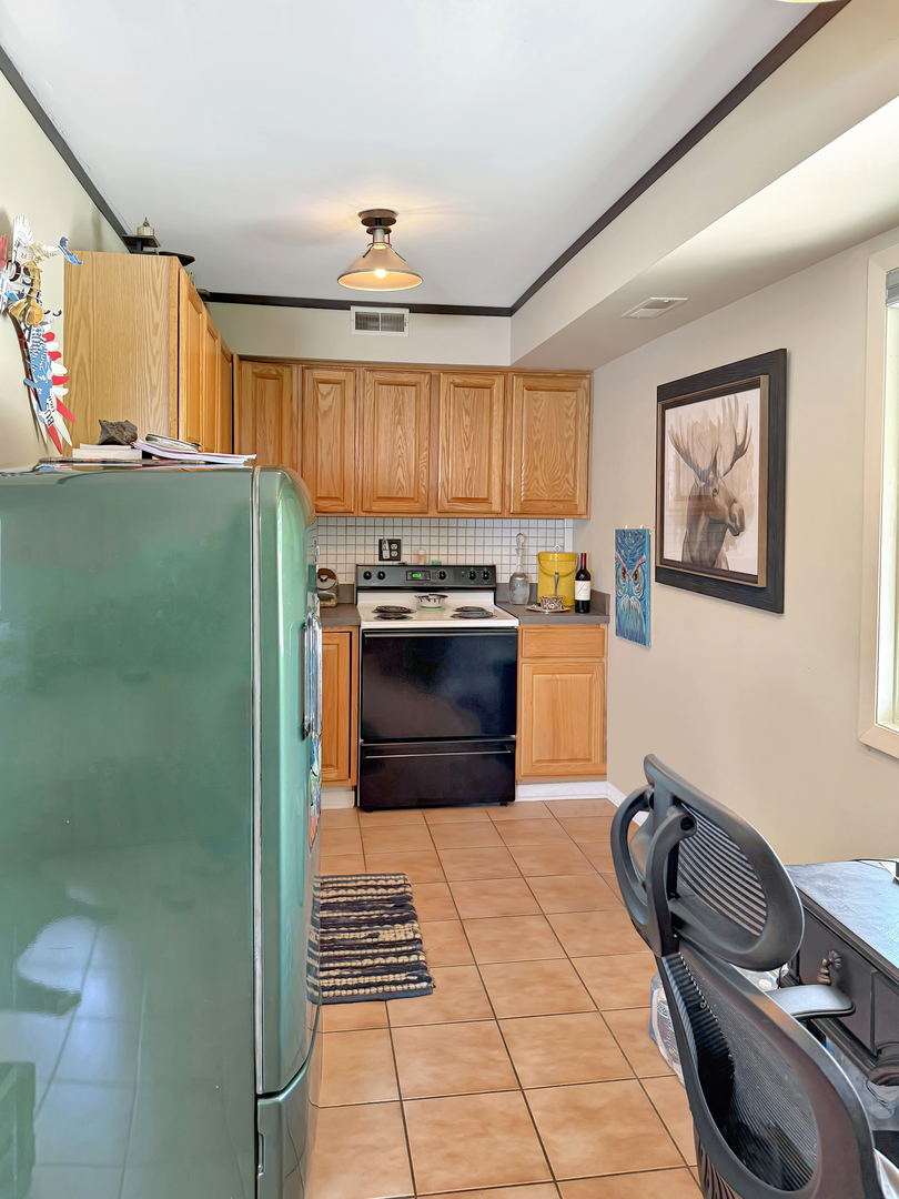 49W972 Peterson Road Maple Park, IL 60151 - Photo 23 of 38 a kitchen with granite countertop a stove a sink and a microwave