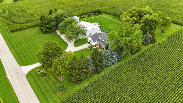a kitchen with a stove a sink a dining table and chairs