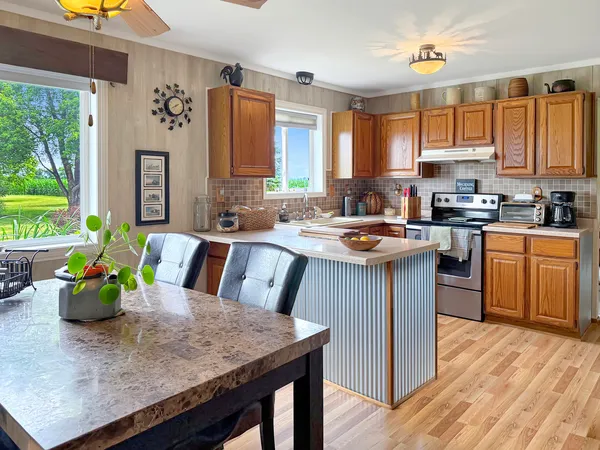 a kitchen with a sink stove and cabinets