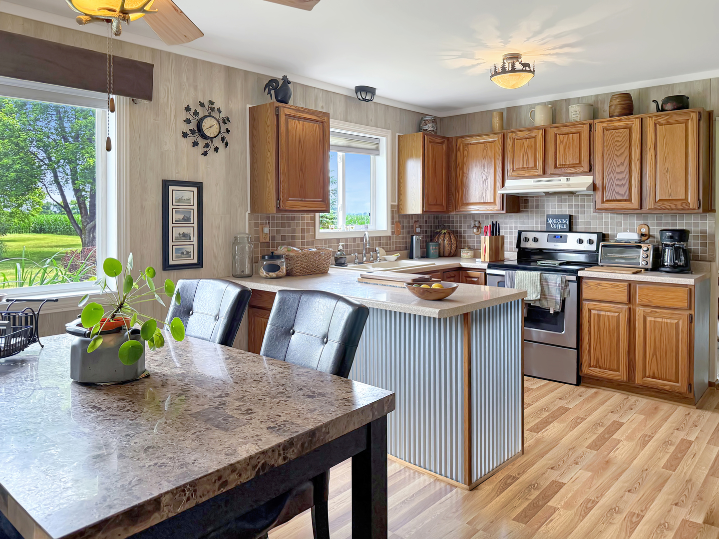 49W972 Peterson Road Maple Park, IL 60151 - Photo 9 of 38 a kitchen with a stove a sink a dining table and chairs