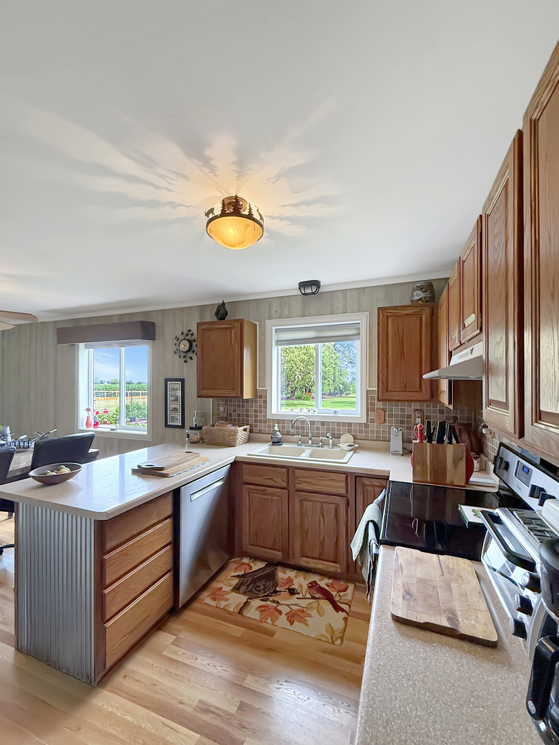 49W972 Peterson Road Maple Park, IL 60151 - Photo 10 of 38 a kitchen with a sink stove and cabinets