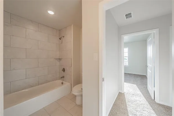 a bathroom with a tub a sink and mirror