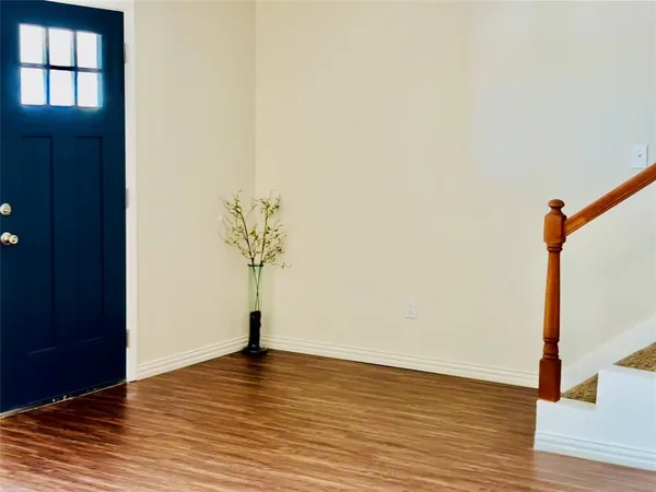 a view of a room with wooden floor and potted plant