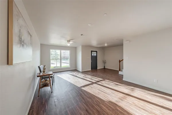 a view of a room with wooden floor and workspace