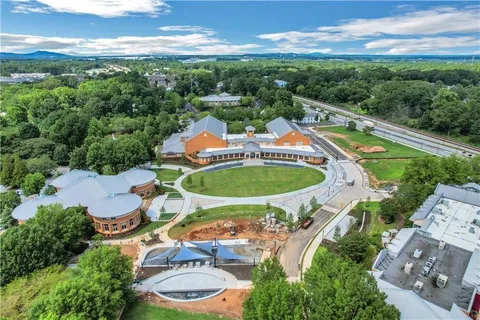 an aerial view of a house with swimming pool outdoor seating and yard