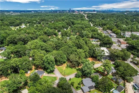 an aerial view of a residential houses with a yard and lake view